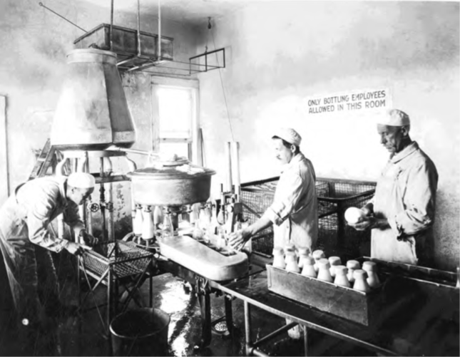 Black and white photograph of people working in a factory from cover of the labor guide.